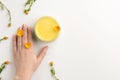 Organic cosmetic concept. Flowers of calendula, female hand and cosmetic cream isolated, on white background Royalty Free Stock Photo