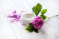 Organic cosmetic with rose and pot of moisturizing face cream on white background Royalty Free Stock Photo