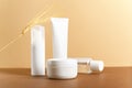 Organic cosmetic white packages with wheat ears composition. Natural skincare products unbranded plastic bottles on beige