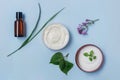 Organic cosmetics: body cream, face cream, serum on light blue background, top view. Royalty Free Stock Photo