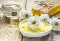 Organic cosmetics with camomile extract on wooden table background Royalty Free Stock Photo