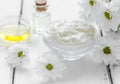 Organic cosmetics with camomile extract on wooden table background Royalty Free Stock Photo