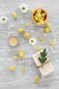 Organic cosmetics with camomile on wooden background top view Royalty Free Stock Photo