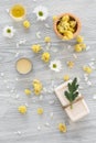 Organic cosmetics with camomile on wooden background top view Royalty Free Stock Photo