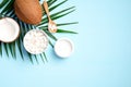 Organic cosmetics with coconut on blue background top view. Skincare, body treatment concept