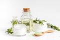 Organic cosmetics with extracts of herbs rosemary on white background