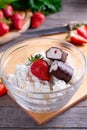 Organic cottage cheese with strawberries in a glass bowl. glazed cheese curds with chocolate