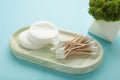 Organic cotton pads and cotton buds for removal makeup on plaster tray on blue background Royalty Free Stock Photo