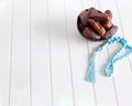 Organic dates Medjool in wooden coconut bowl and rosary. Royalty Free Stock Photo