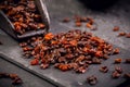 Organic dried berberis and scoop on black blackground Royalty Free Stock Photo