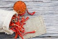 Organic dried red hot peppers on old wooden table, Cayenne pepper in wood bowl Royalty Free Stock Photo