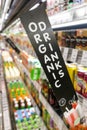 Organic Drinks signage at supermarket refrigerated section, with defocused background
