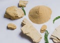 Organic dry clay powder on white background with herbs. natural clay powder for cosmetic industry, spa or home use