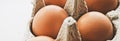 organic eggs in egg box on white marble kitchen table Royalty Free Stock Photo