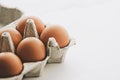 organic eggs in egg box on white marble kitchen table Royalty Free Stock Photo