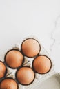 organic eggs in egg box on white marble kitchen table Royalty Free Stock Photo