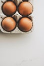 organic eggs in egg box on white marble kitchen table Royalty Free Stock Photo