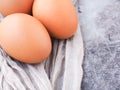Organic eggs from the farm on grey fabric background. High protein and Vitamin foods.
