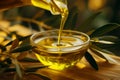 Organic extra virgin olive oil being poured from a glass jar into a bowl Royalty Free Stock Photo