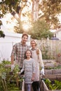 We are an organic family. Portrait of a happy family gardening together in their backyard.