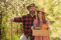 Organic farm. Smiling couple in love gardening. Girl hold box with pots and tools. Farming season. Happy couple ranch Royalty Free Stock Photo