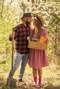 Organic farm. Smiling couple in love gardening. Girl hold box with pots and tools. Soils and fertilizers. Planting Royalty Free Stock Photo