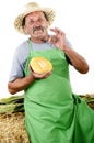 Organic farmer with a half honeydew melon Royalty Free Stock Photo