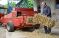 Organic farmer making/stack bales