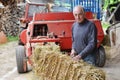 Organic farmer making/stack bales