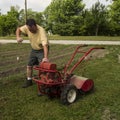Organic Farmer Starting A Old Garden Tiller Royalty Free Stock Photo