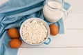 Organic farming cottage cheese in a blue bowl, eggs and milk Royalty Free Stock Photo