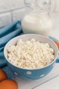 Organic farming cottage cheese in a blue bowl, eggs and milk Royalty Free Stock Photo