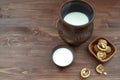 Organic food and antioxidants concept: milk and walnuts on wooden table with copy space Royalty Free Stock Photo