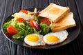 Organic food breakfast: fried eggs with fresh vegetable salad an Royalty Free Stock Photo