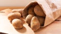 Organic food concept organic fresh potatoes in paper bag on wood board Royalty Free Stock Photo