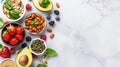 organic food. Fresh berries, nuts, seeds, avocado on light concrete background , copy space