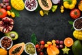 Organic food. Fruits, vegetables, beans and nuts on a black stone background. Top view. Royalty Free Stock Photo