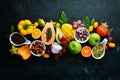 Organic food. Fruits, vegetables, beans and nuts on a black stone background. Top view. Royalty Free Stock Photo