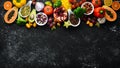 Organic food. Fruits, vegetables, beans and nuts on a black stone background. Top view. Royalty Free Stock Photo