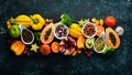 Organic food. Fruits, vegetables, beans and nuts on a black stone background. Top view. Royalty Free Stock Photo