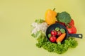 Organic food. Healthy vegetables with broccoli, lettuce, red and yellow sweet pepper, cucumber on a black skillet. Top view. Vegan Royalty Free Stock Photo