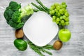 Organic food for homemade salad with green vegetables and plate gray desk background top view mock-up Royalty Free Stock Photo