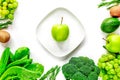 Organic food for homemade salad with green vegetables and plate white desk background top view mock-up Royalty Free Stock Photo