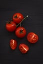 Organic fresh cherry tomatoes on black board background Royalty Free Stock Photo