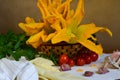 Organic and fresh courgette and zucchini flowers, summer harverst on wooden table Royalty Free Stock Photo