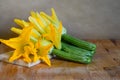 Organic and fresh courgette and zucchini flowers, summer harverst on wooden table Royalty Free Stock Photo