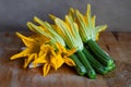 Organic and fresh courgette and zucchini flowers, on wooden table Royalty Free Stock Photo