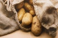 Organic fresh potatoes in a jute sack. Market scene