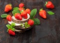 Organic fresh raw strawberries with leaf on timber round boards on dark background Royalty Free Stock Photo