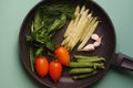 Organic fresh vegetables courgette, tomato, asparagus, basil, dill, green peas, garlic in a frying pan Royalty Free Stock Photo